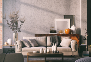 iNTERNO DI UN soggiorno elegante e grigio con un divano delle piante un tavolino d'appoggio e una luce naturale che entra da sinistra a destra